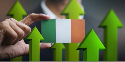 Nation Growth Concept, Green Up Arrows - Businessman Holding Card of Ireland Flag